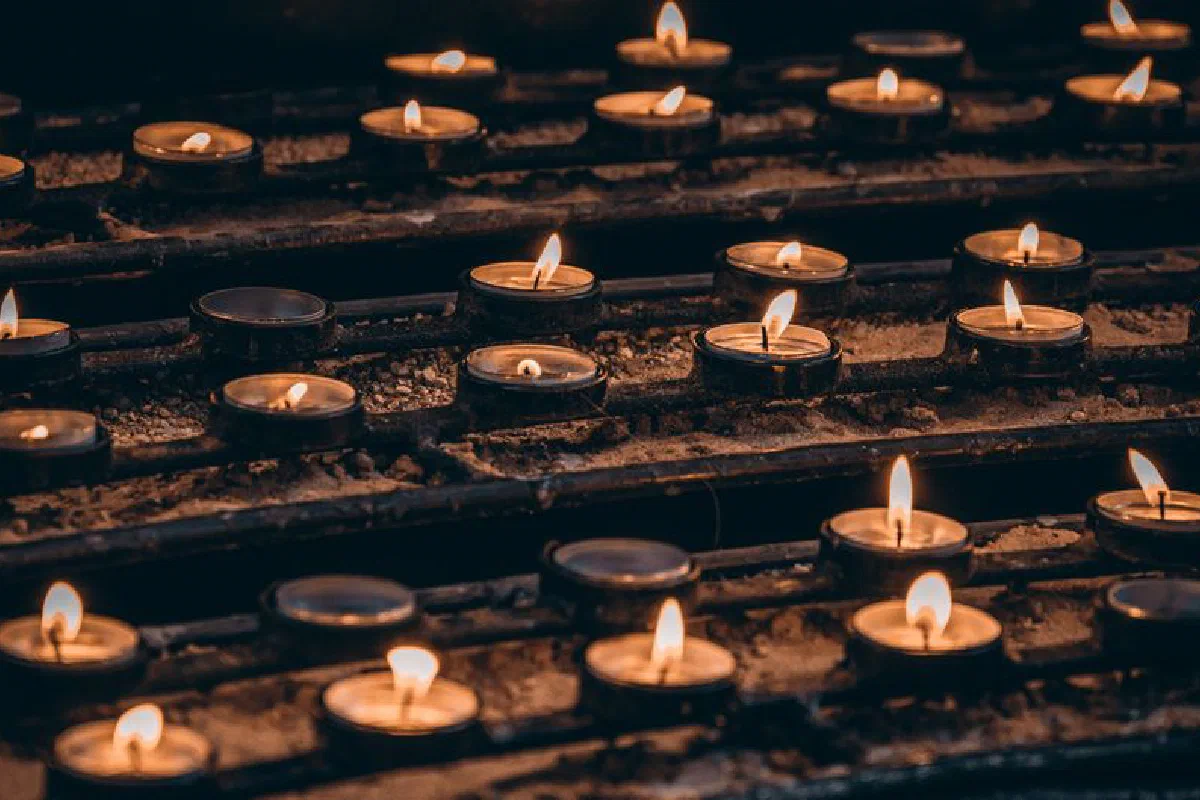 Close-up of candles creating a warm, peaceful ambiance in a church setting.