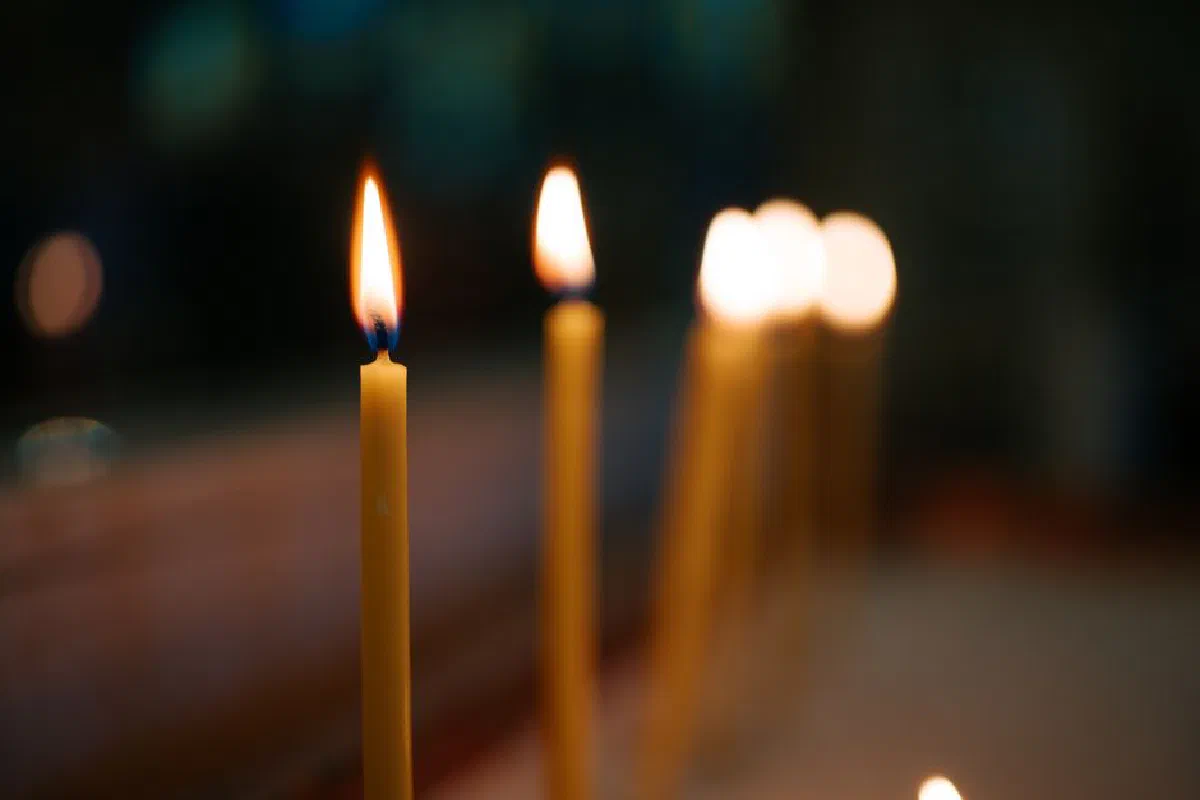 Close-up of lit candles creating a serene atmosphere with soft bokeh in the background.