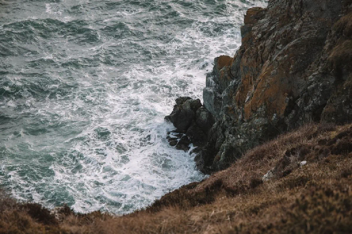 Captivating seascape of cliffs and waves crashing in Dublin, Ireland.