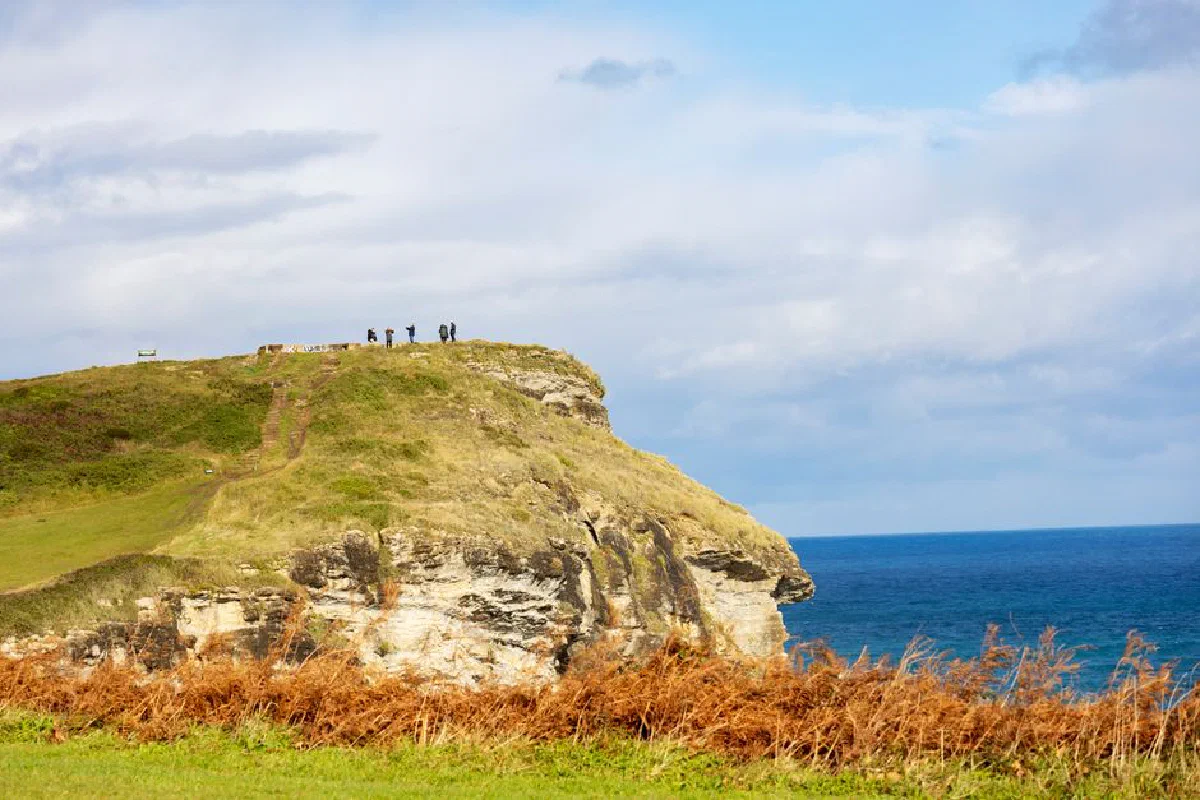 Explore the breathtaking cliffs of Santander, Spain with a stunning view of the vast ocean.