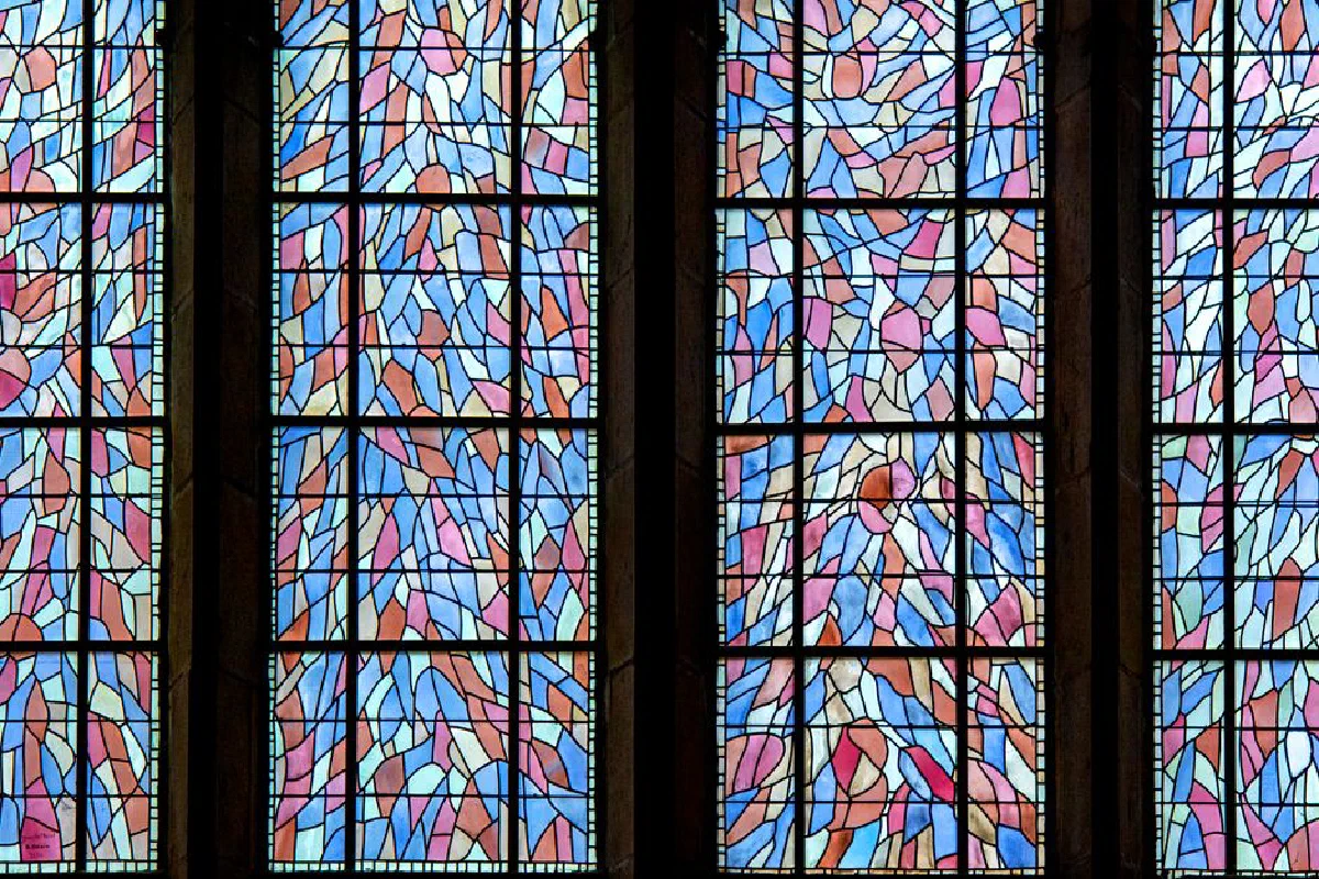 Vibrant stained glass art showcases intricate designs in church windows.
