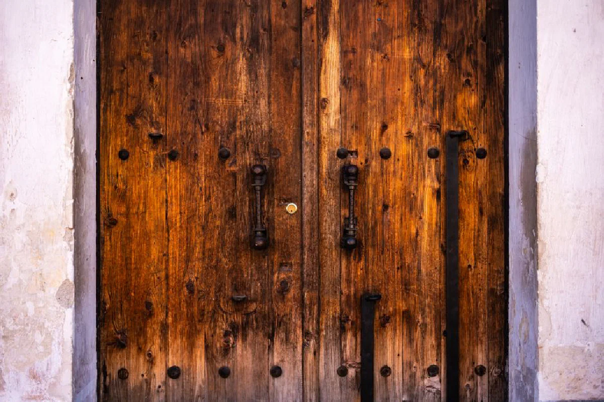 Close-up of a vintage wooden door in Antigua Guatemala showcasing rustic charm.