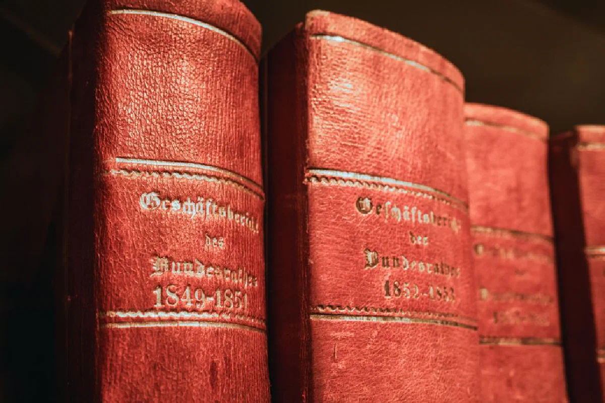 Red leather-bound parliamentary books from 19th century in Bern library, Switzerland.