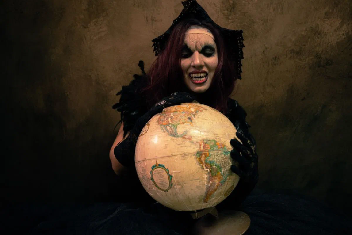 Gothic-themed portrait of a woman holding a globe, exuding a dark and mysterious aura.