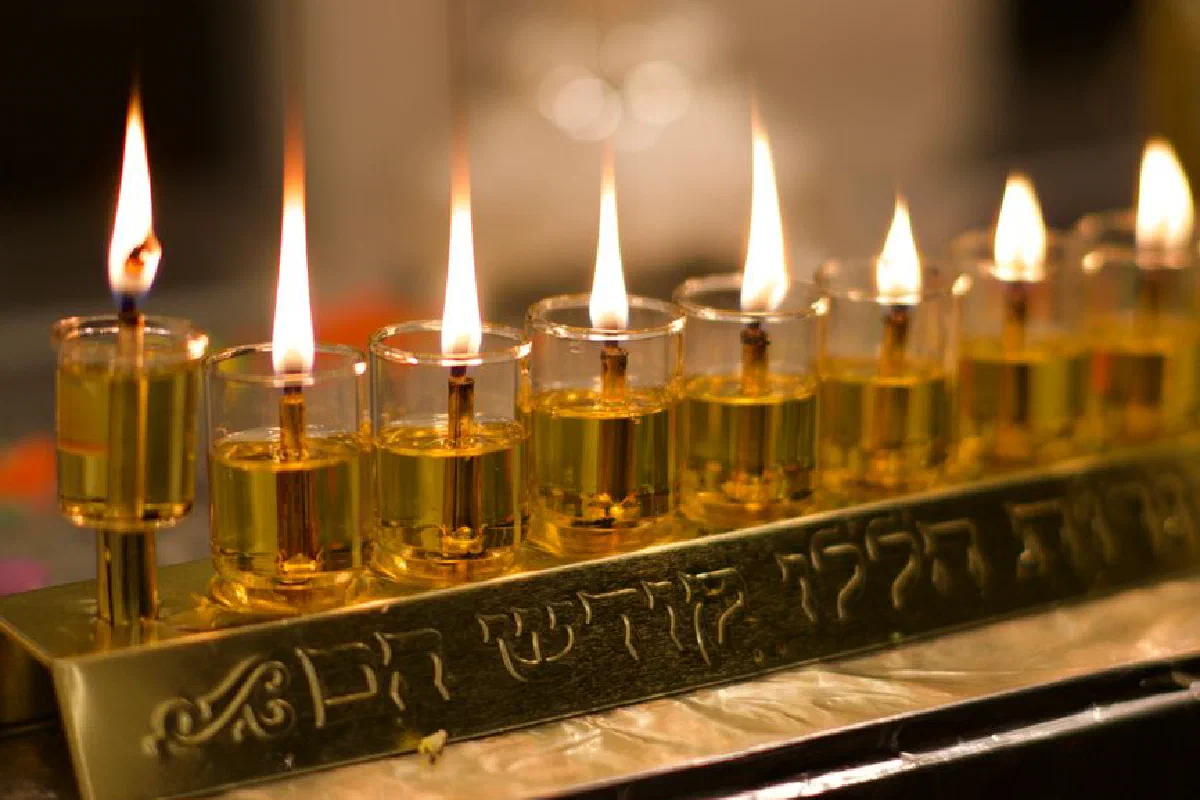 A beautifully lit Hanukkah menorah with Hebrew script, symbolizing the festival of lights.