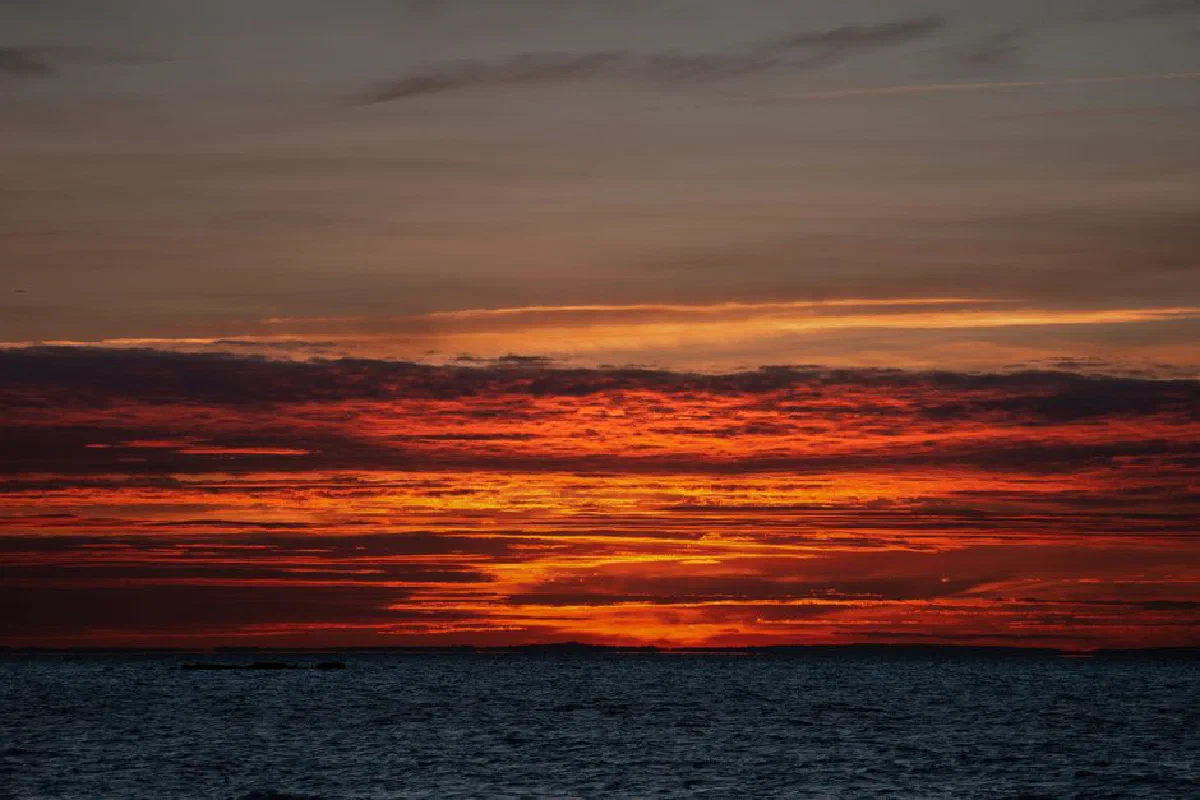 A stunning sunrise over the ocean with vivid colors in Stamford, Connecticut.