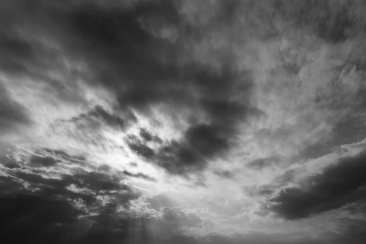 A moody black and white photo of storm clouds, capturing a dramatic and atmospheric scene.