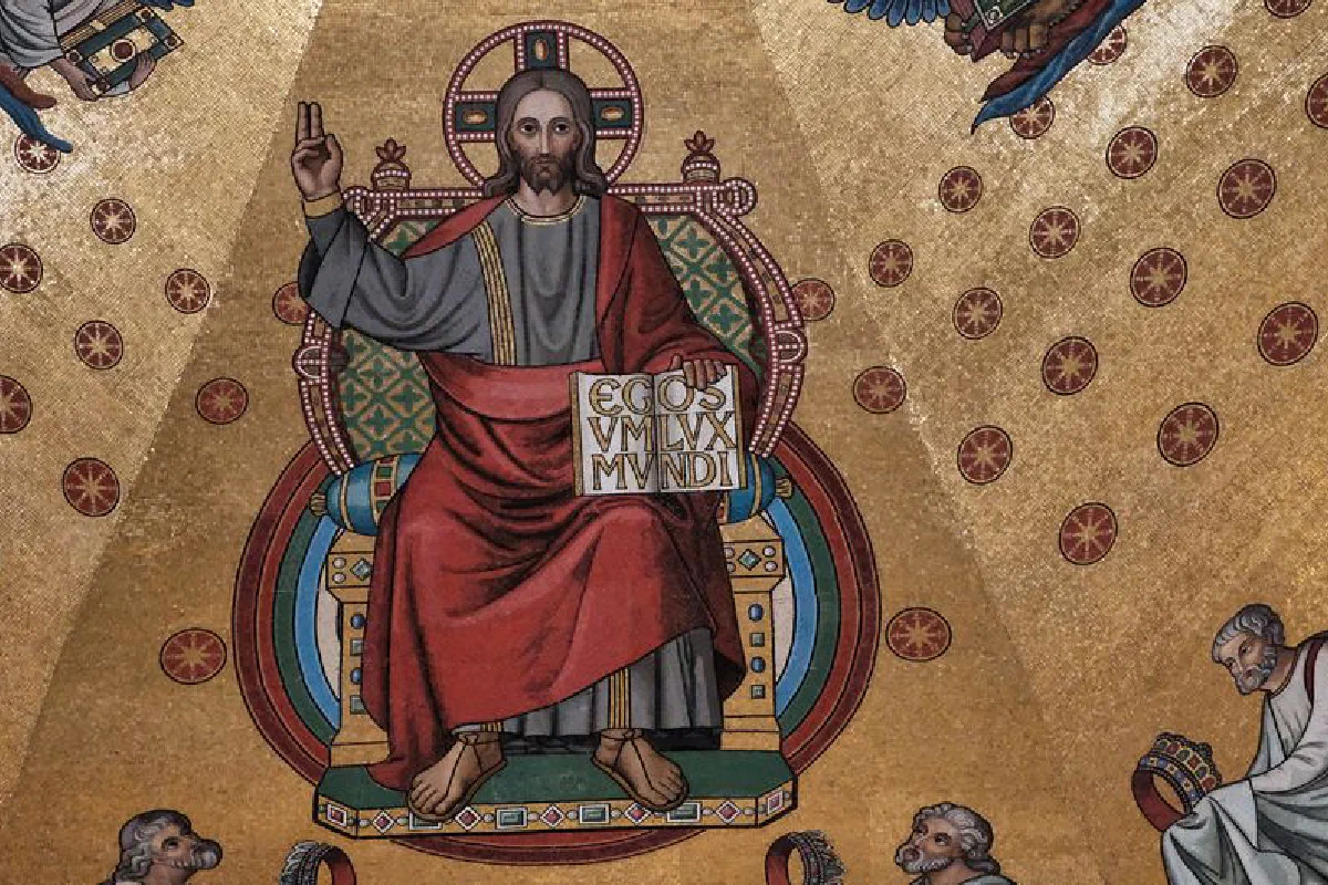 Detailed fresco of Jesus Christ with a symbolic gesture and scripture in a church setting.