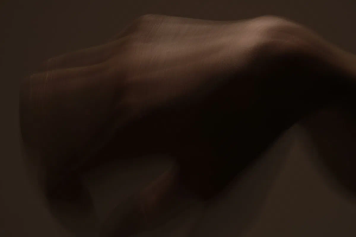 Surreal blurred motion image of a hand creating an abstract visual effect.