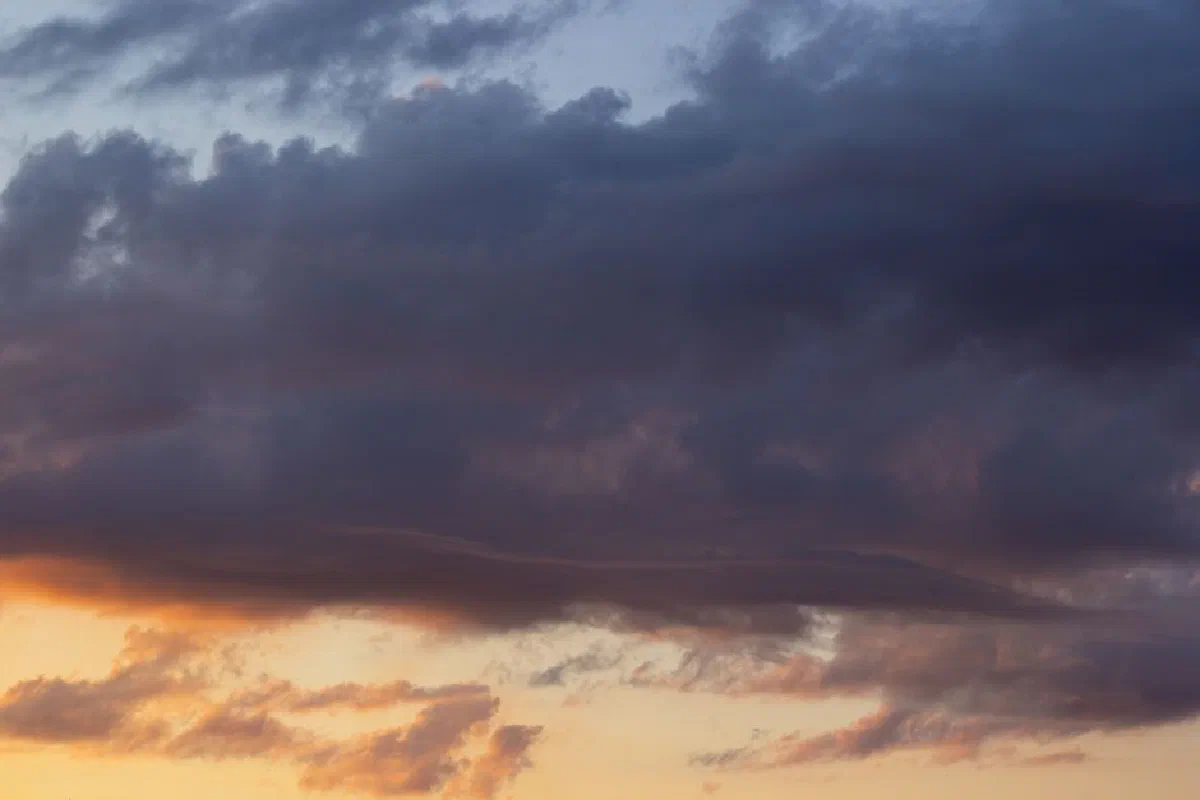 Beautiful sunset with dramatic storm clouds forming in the sky.