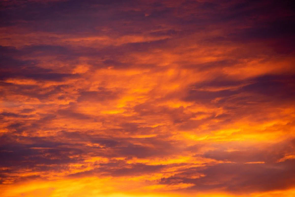 A stunning sunset sky with vibrant orange and purple hues creating a dramatic natural scene.