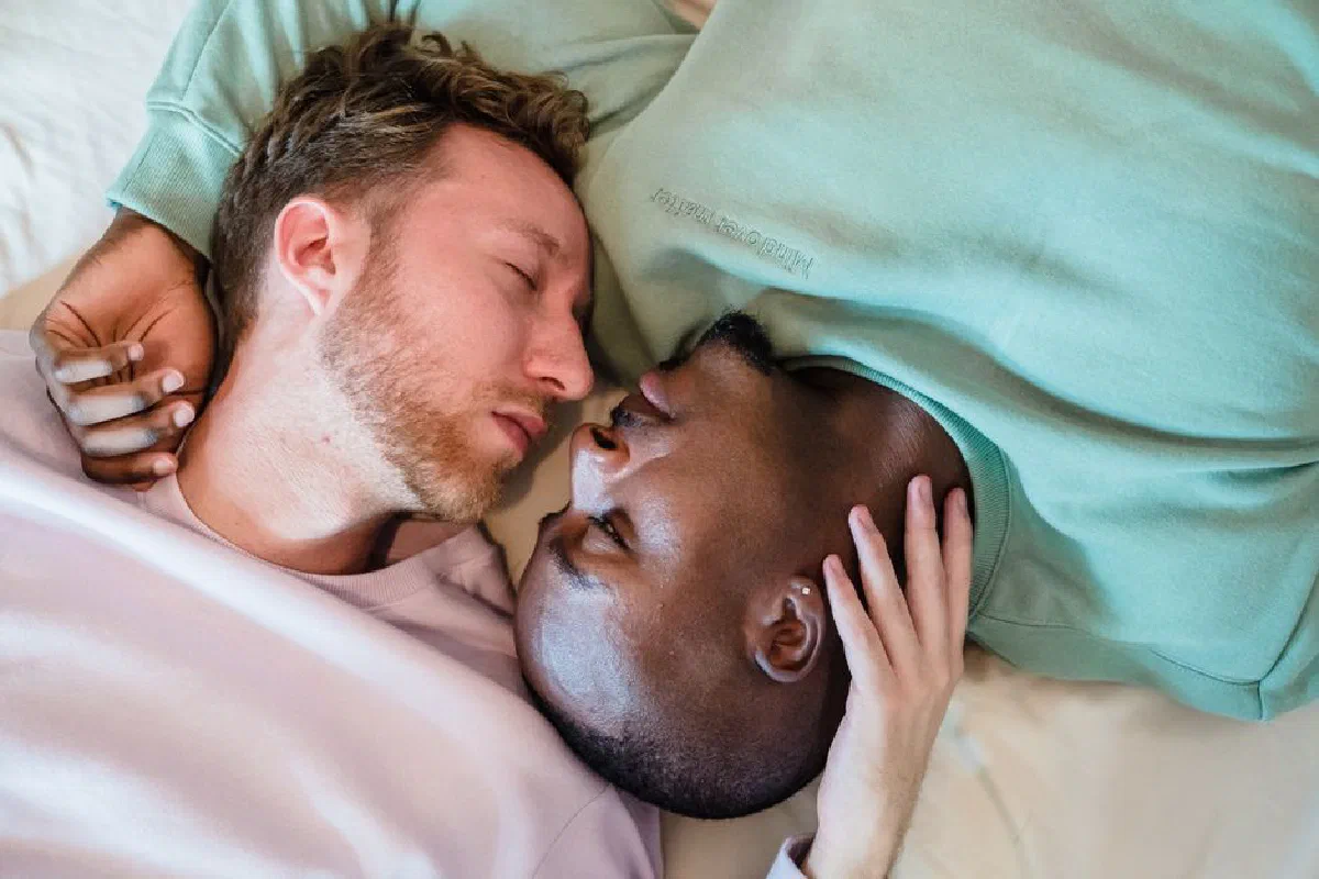 A tender and intimate moment captured between a loving couple relaxing indoors.
