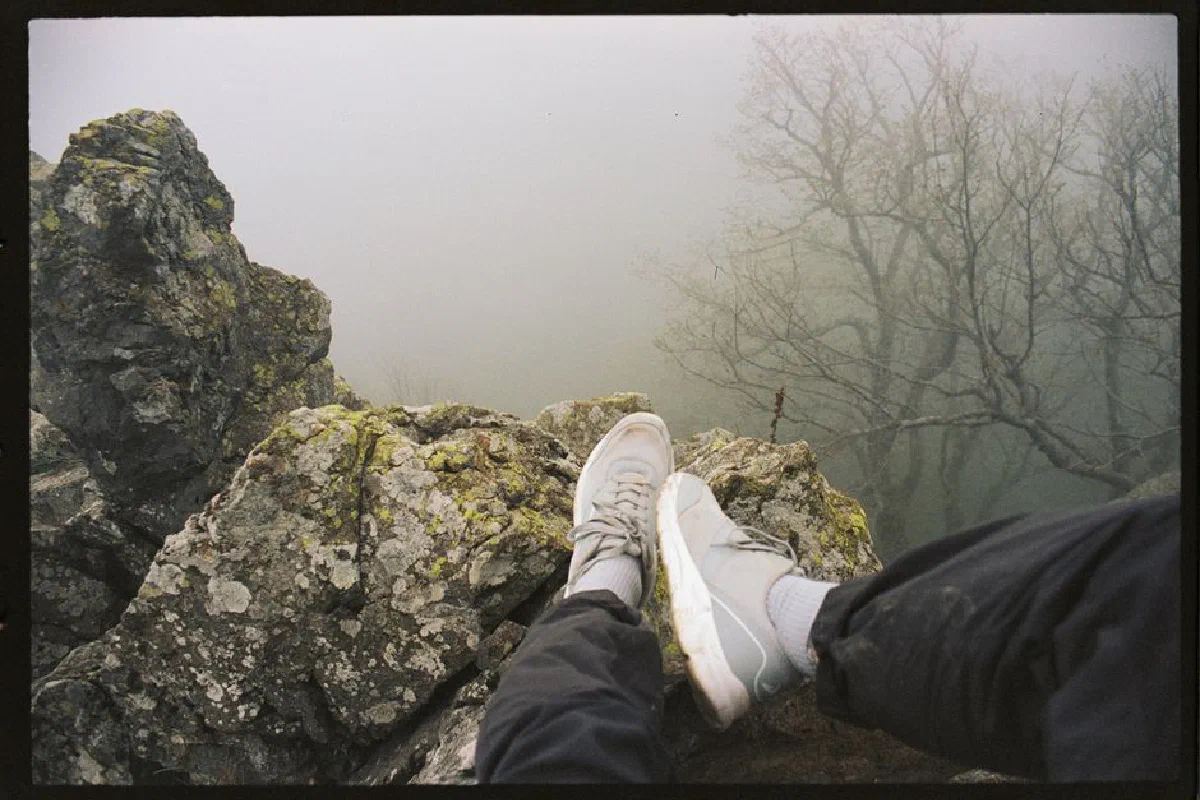 Experience the thrill of a foggy mountain view while relaxing on a cliff edge in Tuapse, Russia.
