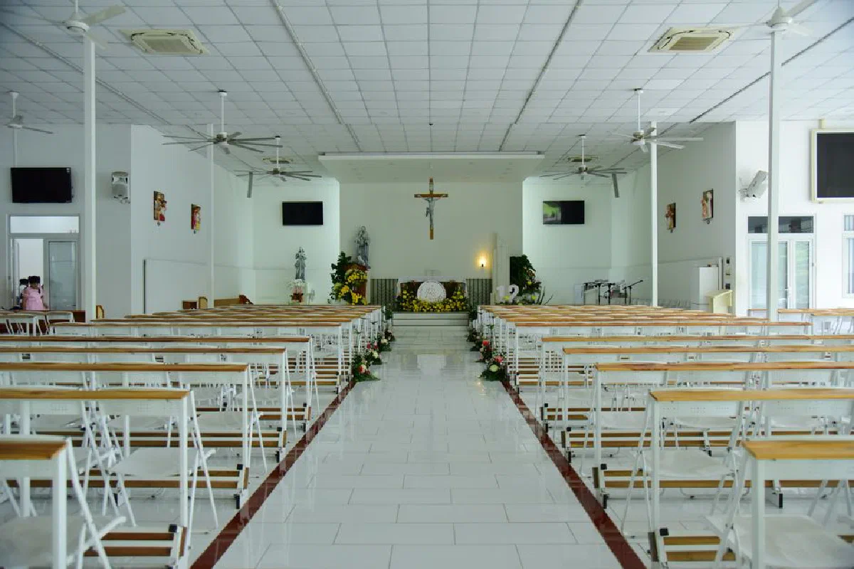 Spacious, bright church interior focused on the altar and seating arrangement.