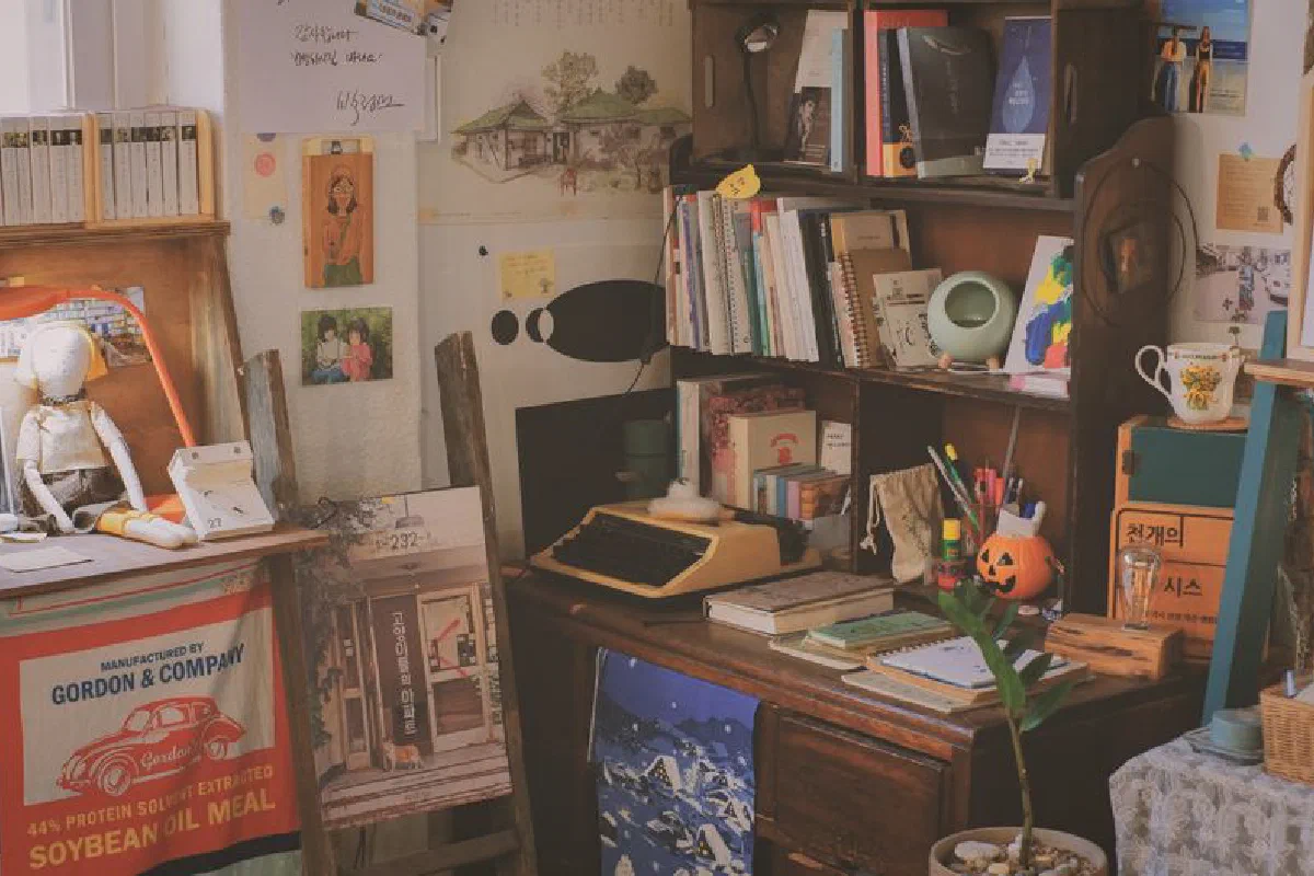 A warm, cluttered study filled with books, a typewriter, and vintage decor creating a cozy ambiance.