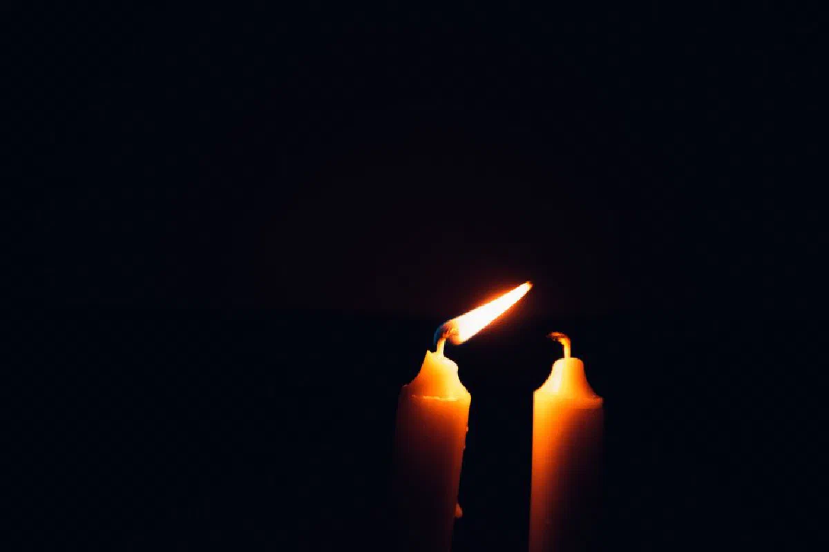 Close-up of burning candles in the dark, creating a warm and intimate atmosphere.