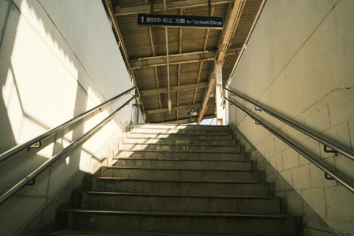 View of Toyota station subway stairs with directional signage in Japan.