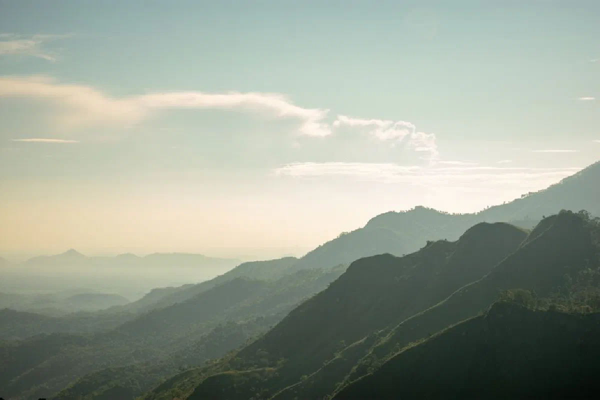 Serene view of misty mountains in Mirissa, Sri Lanka, during a tranquil morning.