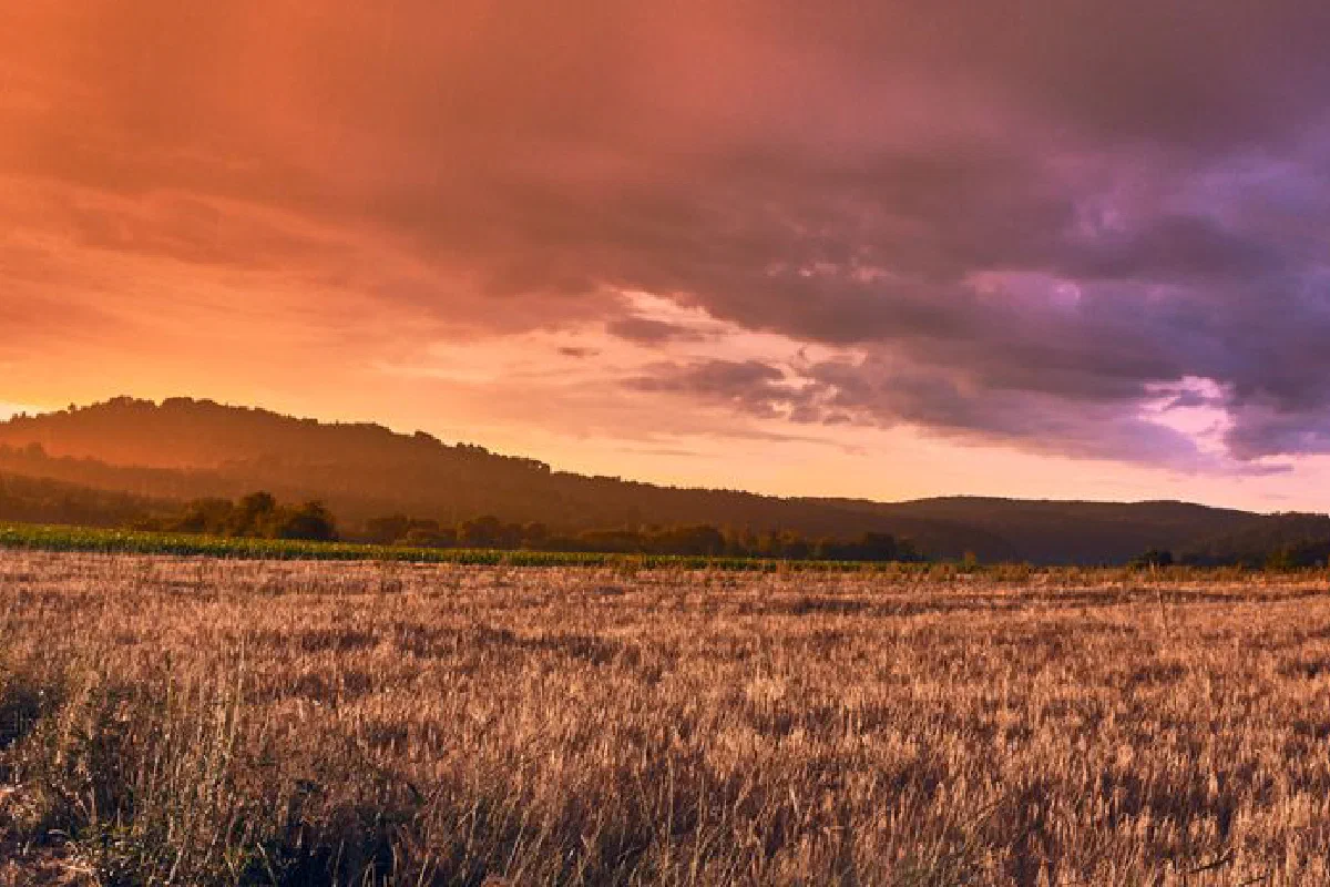 Beautiful sunset over a rural farmland landscape in Niederdorla, Germany, with dramatic skies.