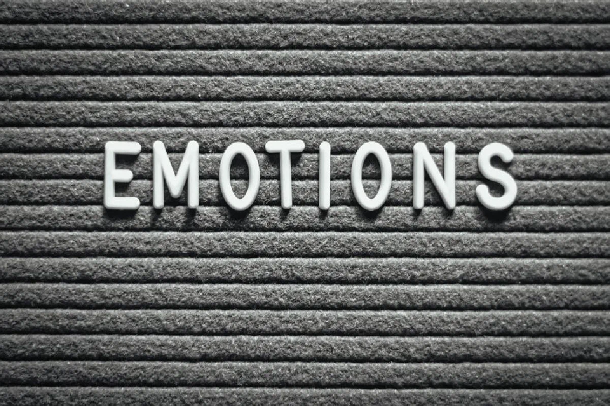 Letter board with the word 'Emotions' on a gray lined background.