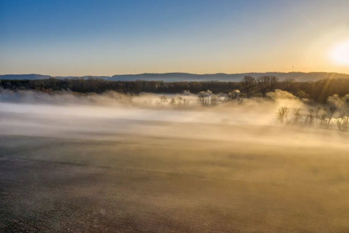 Aerial view of a foggy sunrise over rural fields in Minnesota, USA.