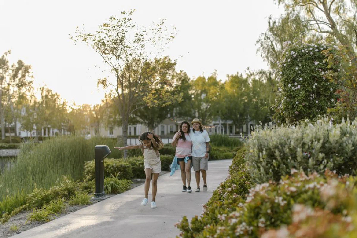 A joyful family moment captured during a peaceful walk in the park at sunset.