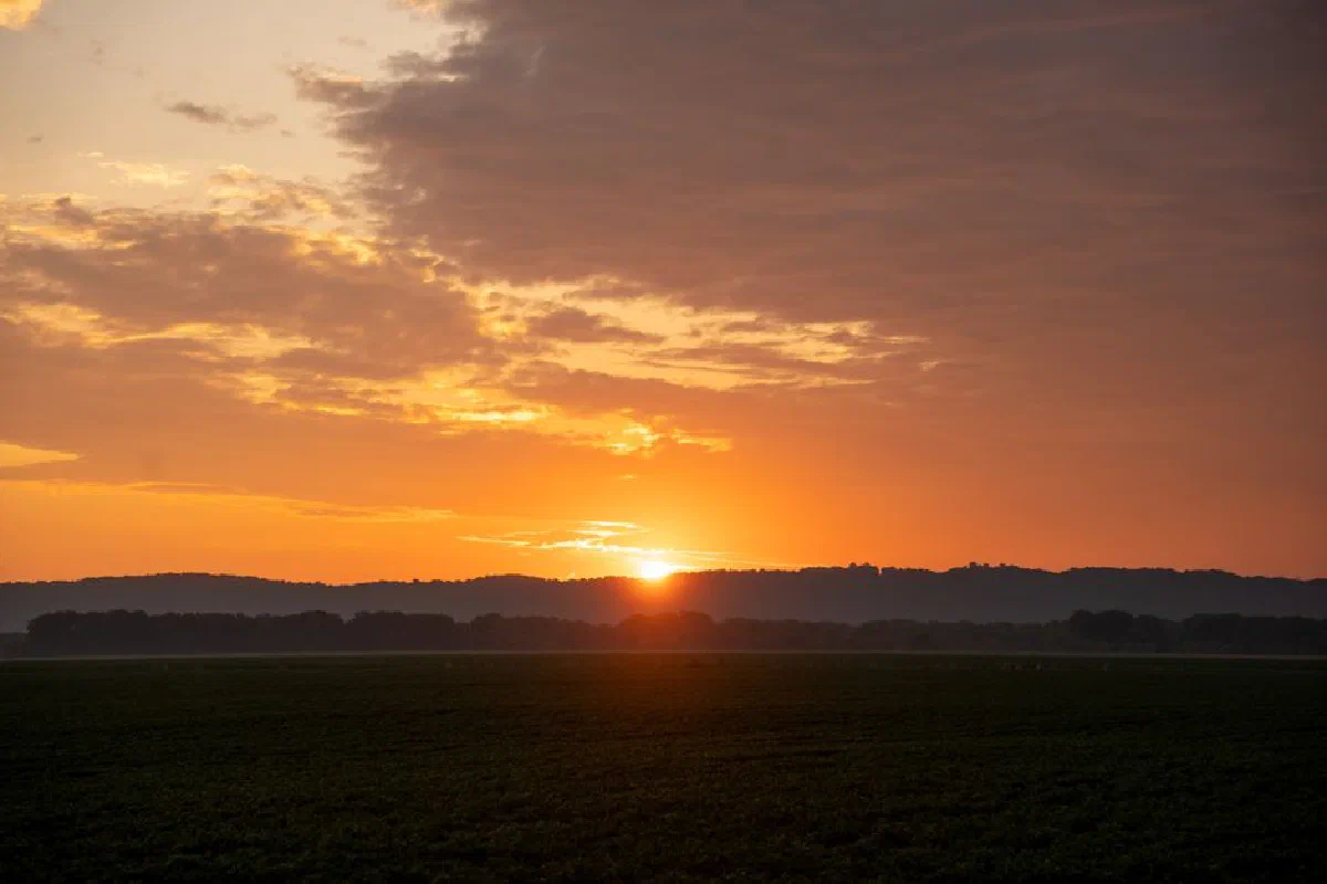 Breathtaking sunset over rural fields in Kellogg, Minnesota with vibrant sky colors.