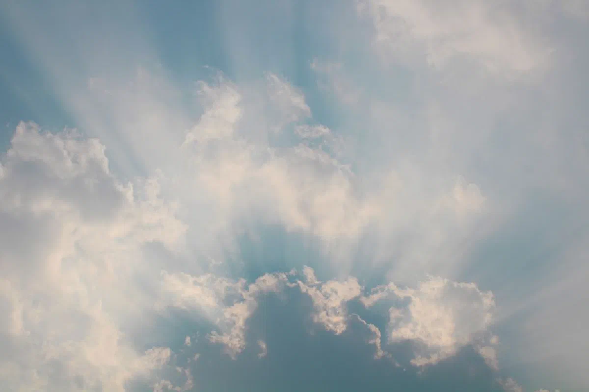 A beautiful cloudscape with sun rays streaming through clouds, creating a serene and peaceful atmosphere.