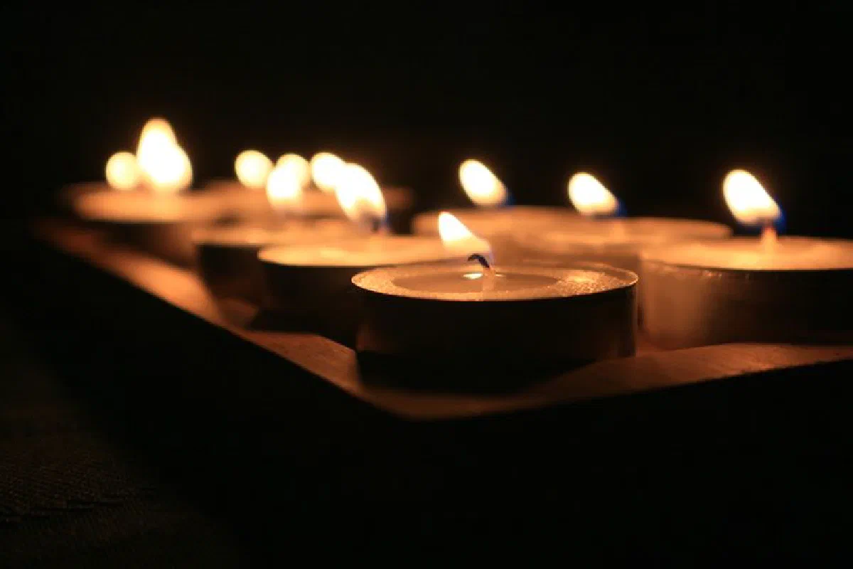 Close-up of burning candles creating a warm and solemn ambiance.