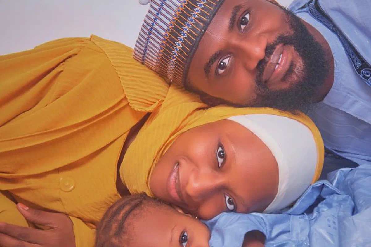 A joyful African family lying together, showcasing love and connection in Birnin Gwari, Nigeria.