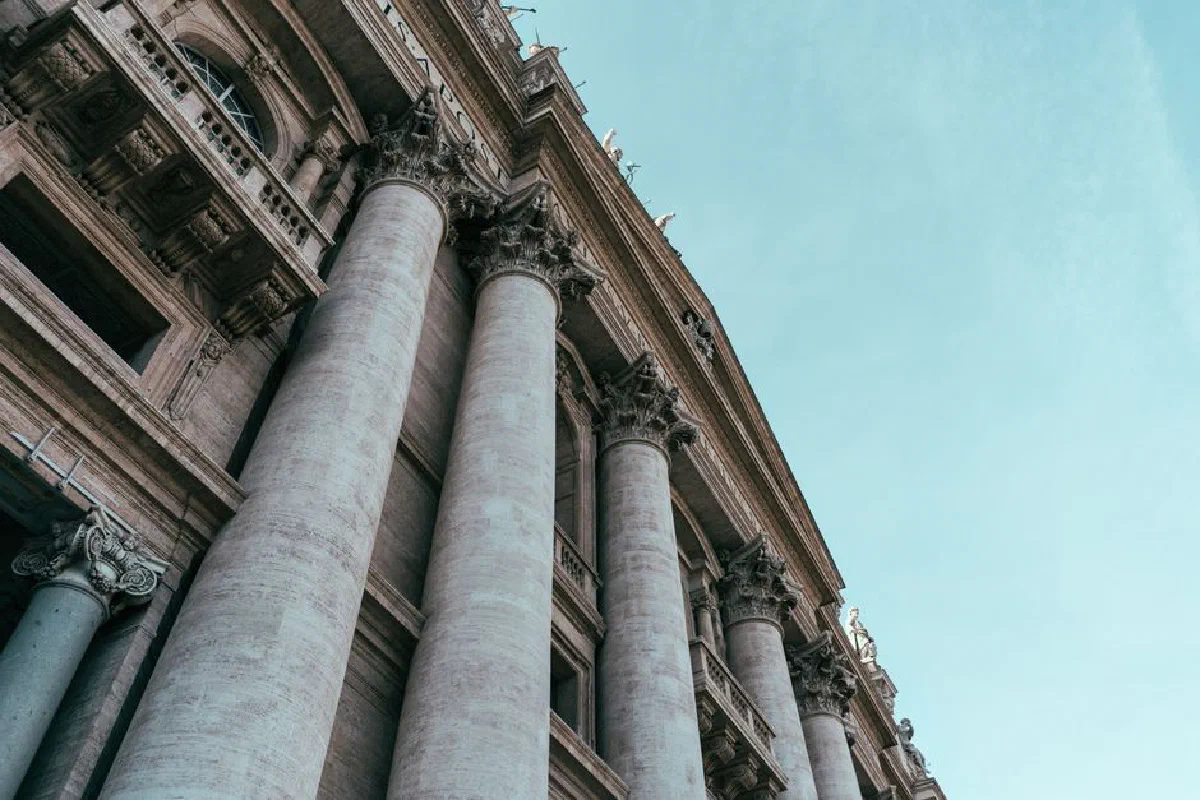 View of the majestic columns of St. Peter's Basilica in the Vatican, showcasing timeless architecture.