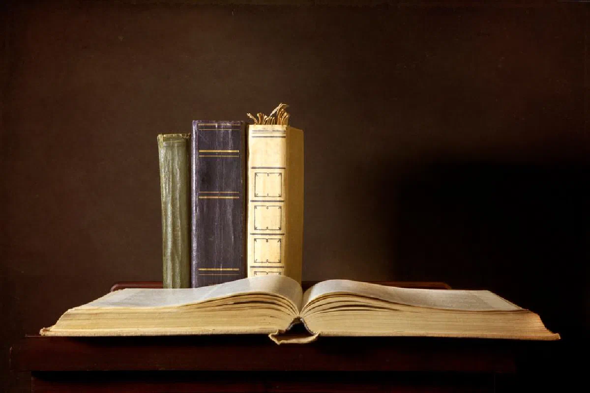 A timeless collection of vintage leather-bound books artfully arranged against a classic backdrop.