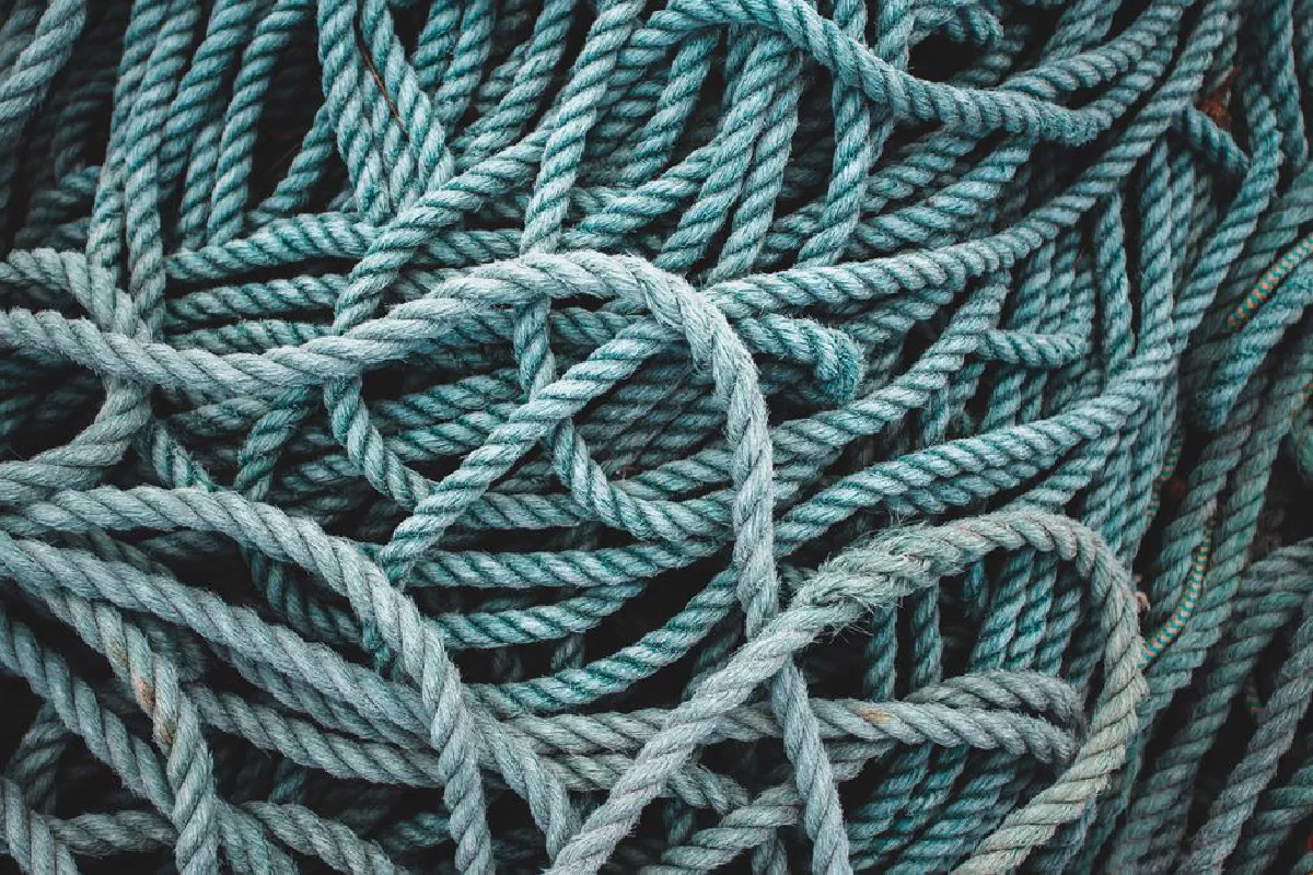 Intricate close-up of tangled blue ropes creating a textured pattern.