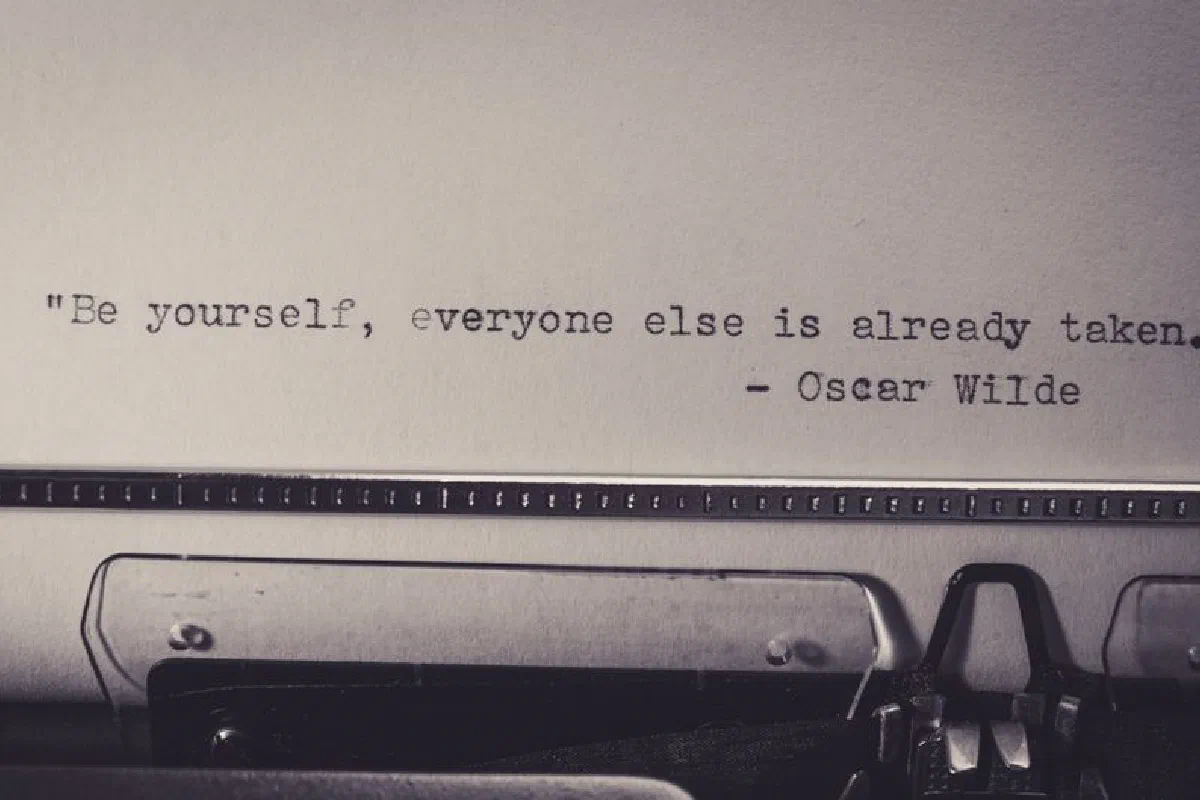 Vintage typewriter displaying Oscar Wilde's quote 'Be yourself, everyone else is already taken.'