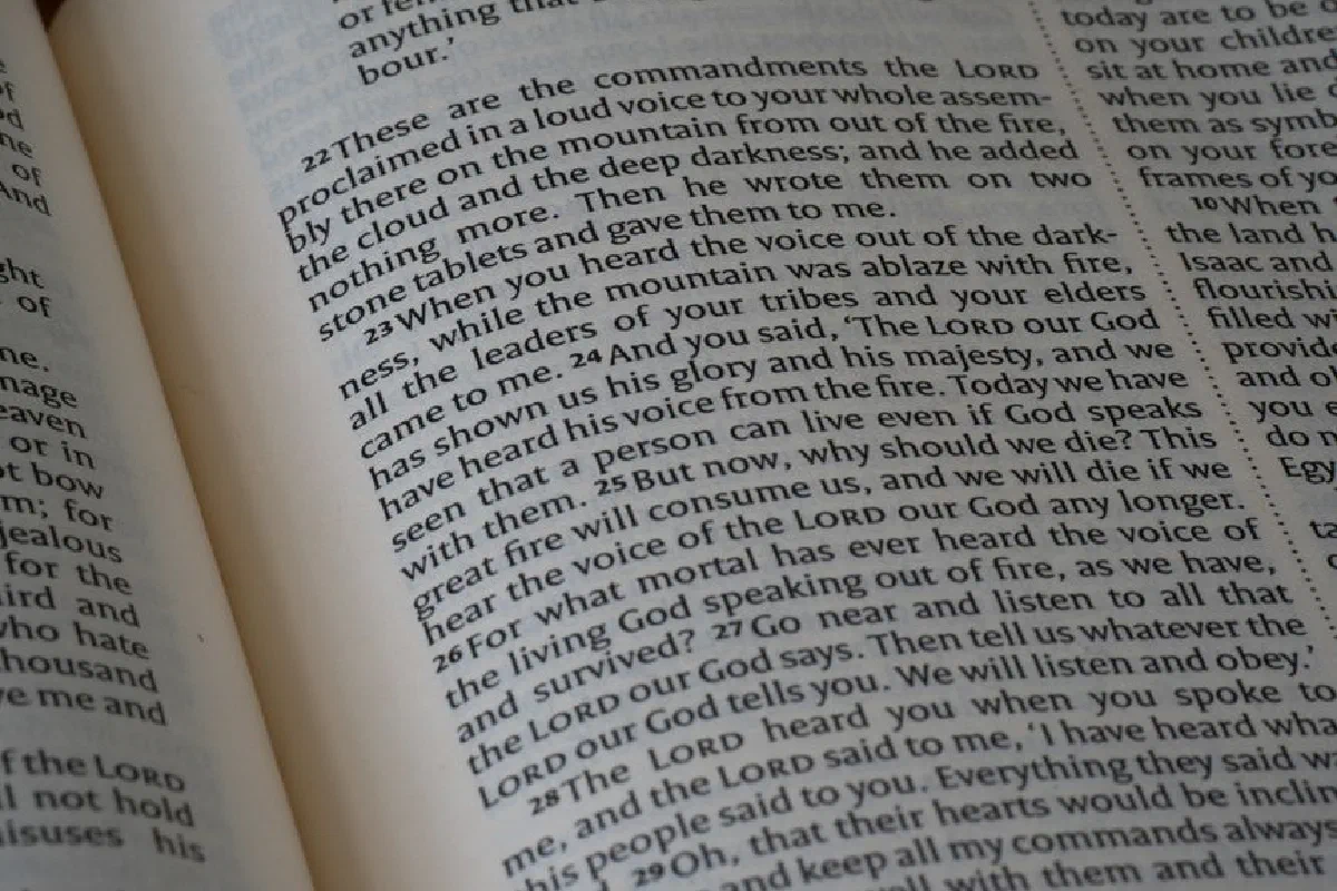 Detailed close-up of a Bible page showing text from the book of Deuteronomy.