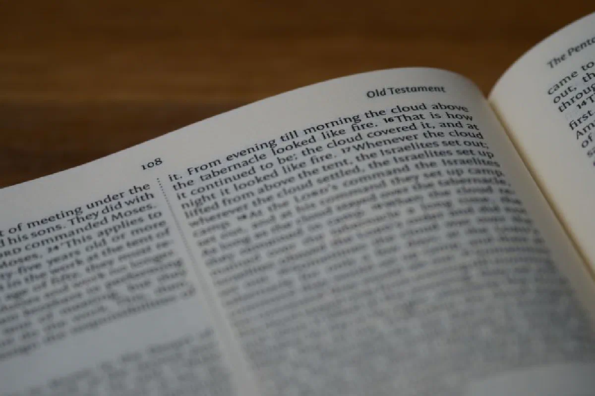 Close-up of an open Bible displaying Old Testament scriptures with focus on text.
