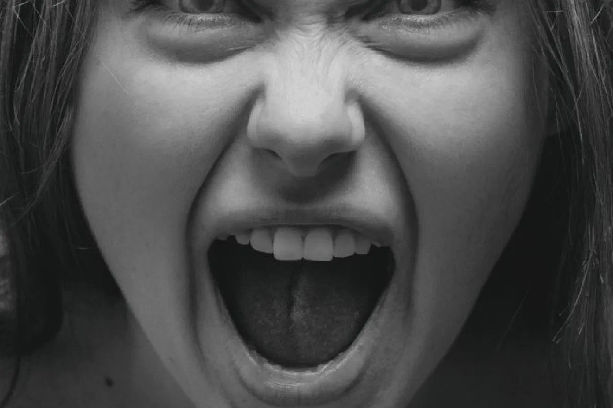 Dramatic grayscale portrait capturing a woman's intense facial expression in Kyiv.
