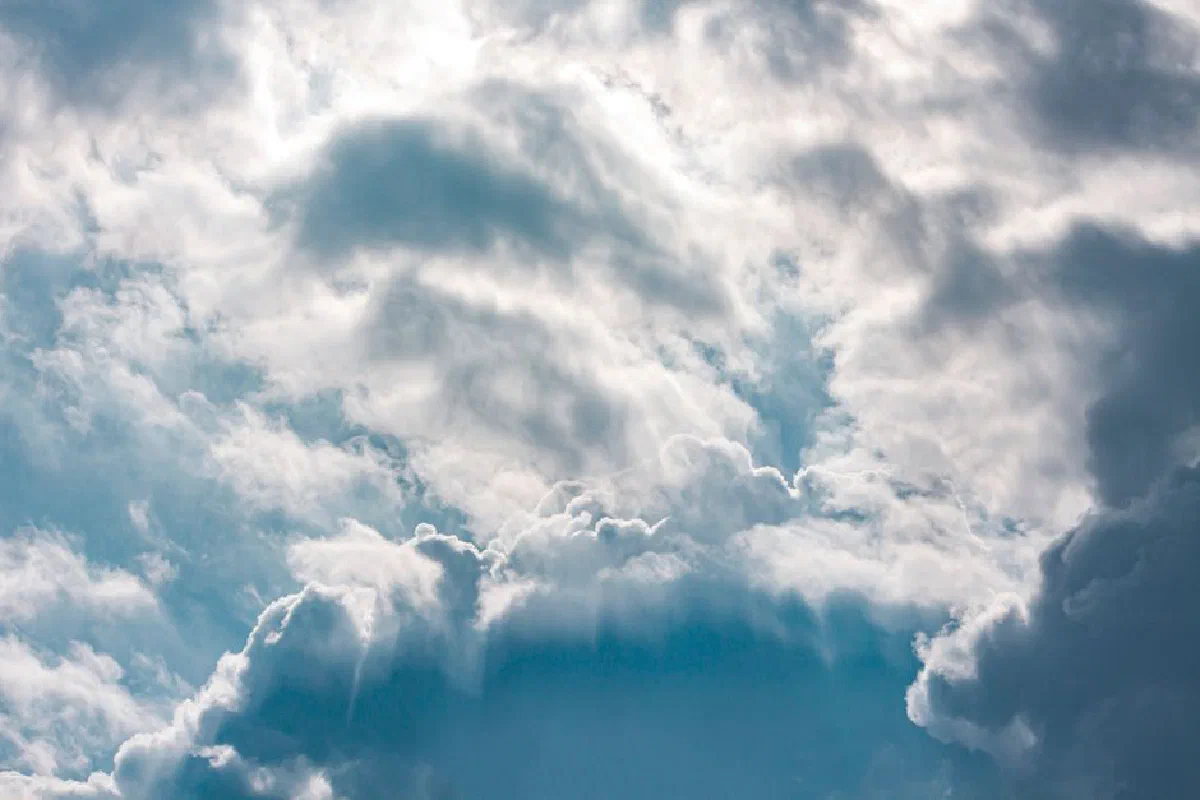 A dreamy and dramatic view of fluffy clouds in a bright blue sky over Adana, Turkey.