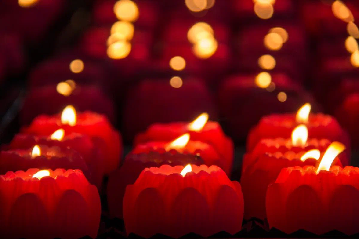 Rows of glowing red candles create a warm and festive atmosphere perfect for celebrations.
