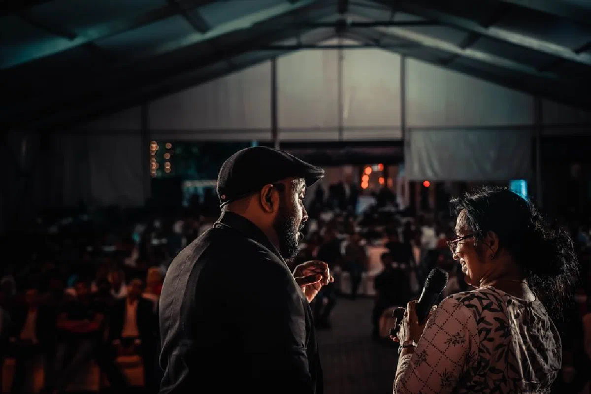 Performers captivating the audience at an evening indoor event, rich in ambiance and energy.