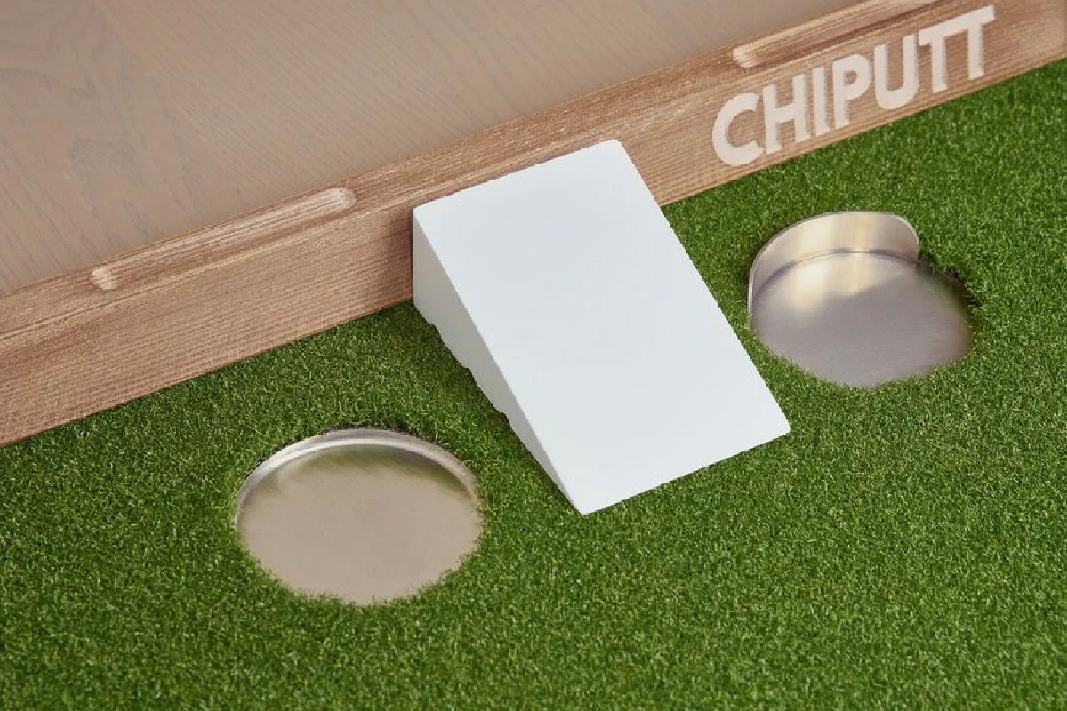 Enhance your golf skills with this innovative chip and putt training aid featuring artificial turf and multiple practice holes.