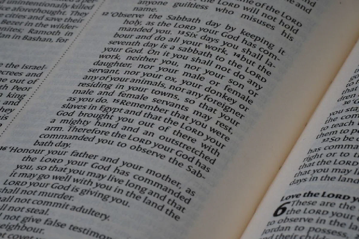 Close-up of an open Bible showing text from the Book of Deuteronomy, emphasizing scripture.
