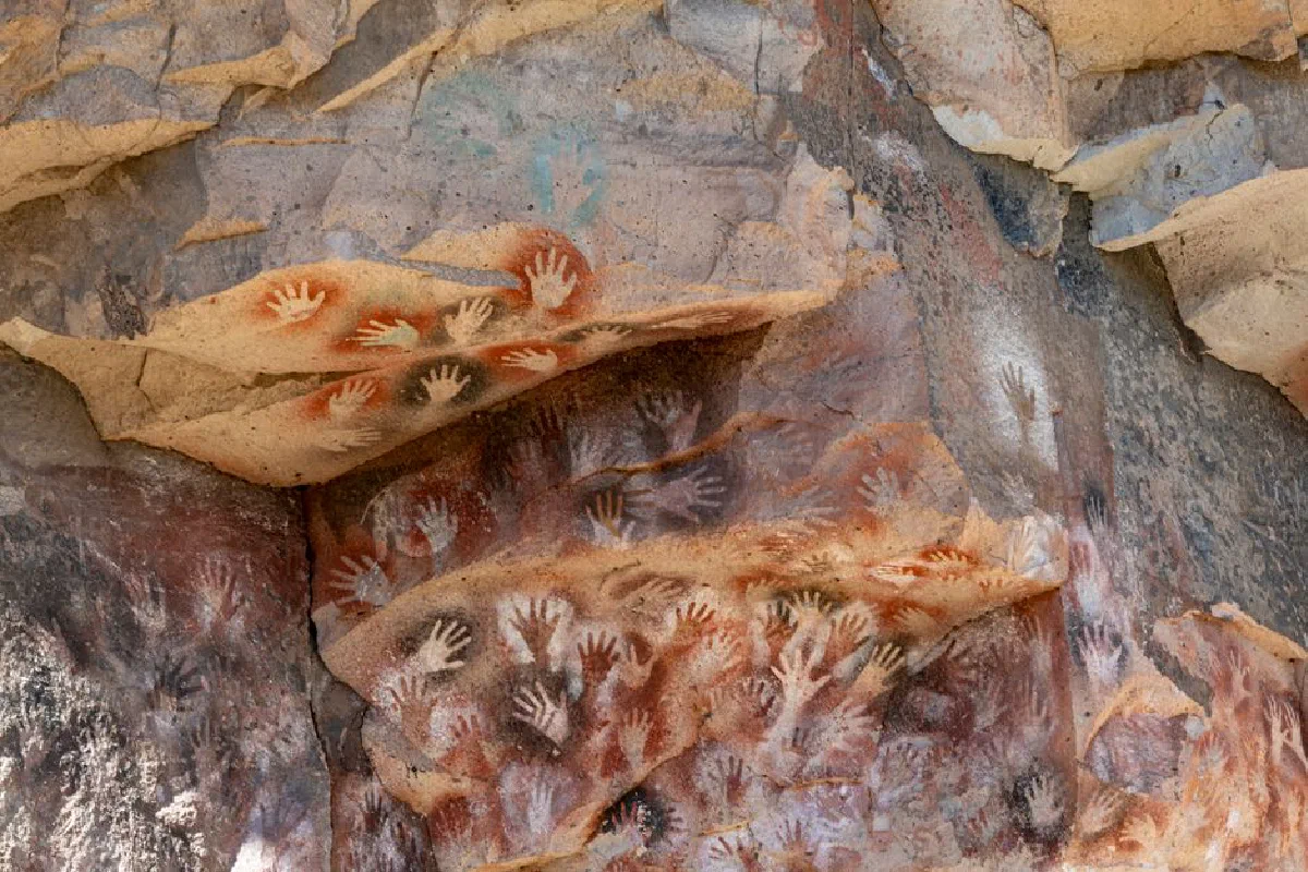 Ancient handprints on cave walls in Santa Cruz, a classic example of prehistoric rock art.
