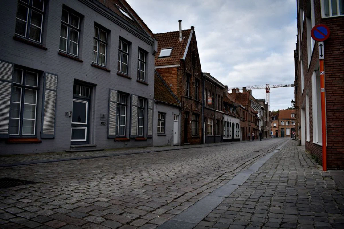 Quaint European street with cobblestone pavement and historic architecture.