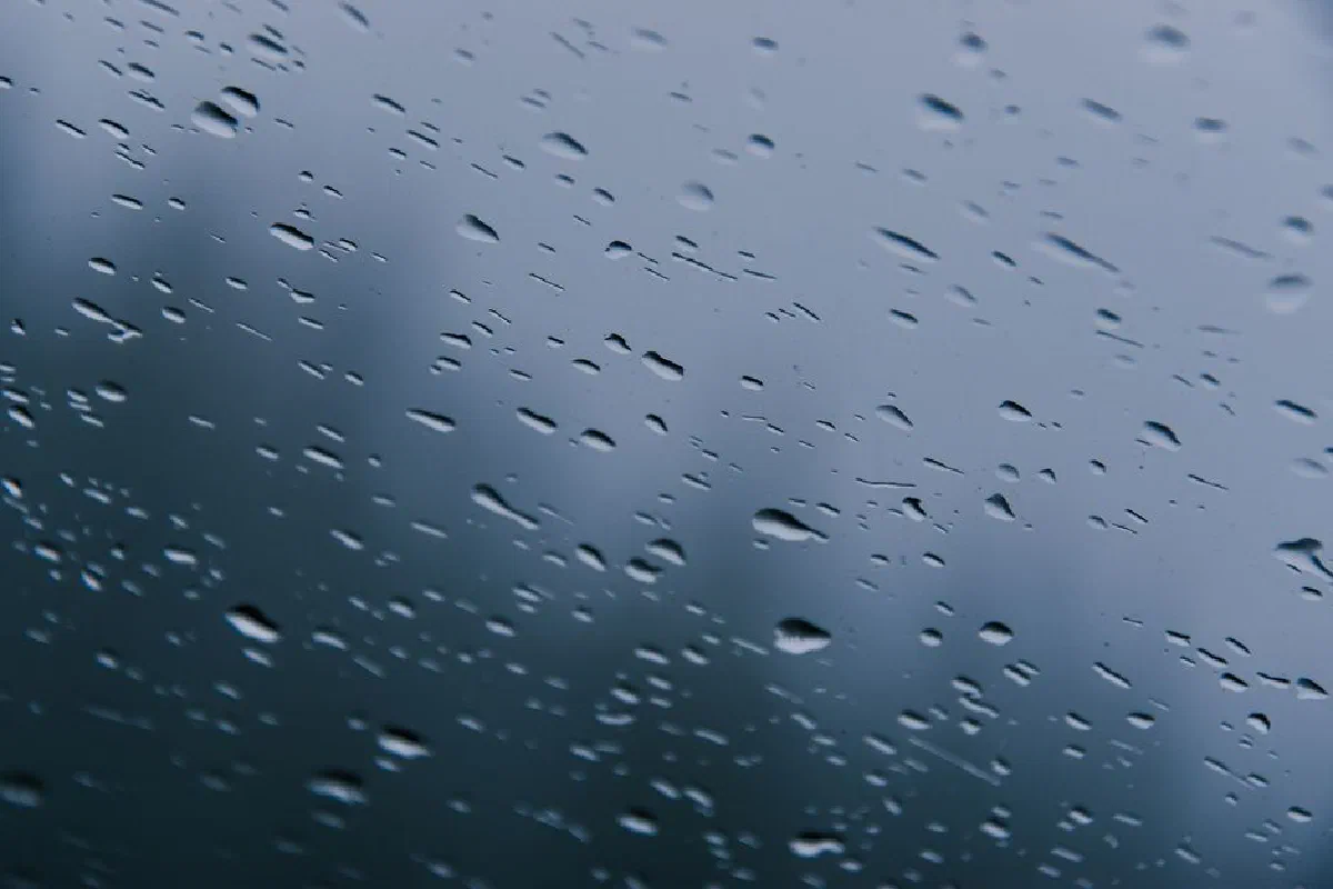 Close-up view of raindrops on a window, capturing the essence of a stormy day.