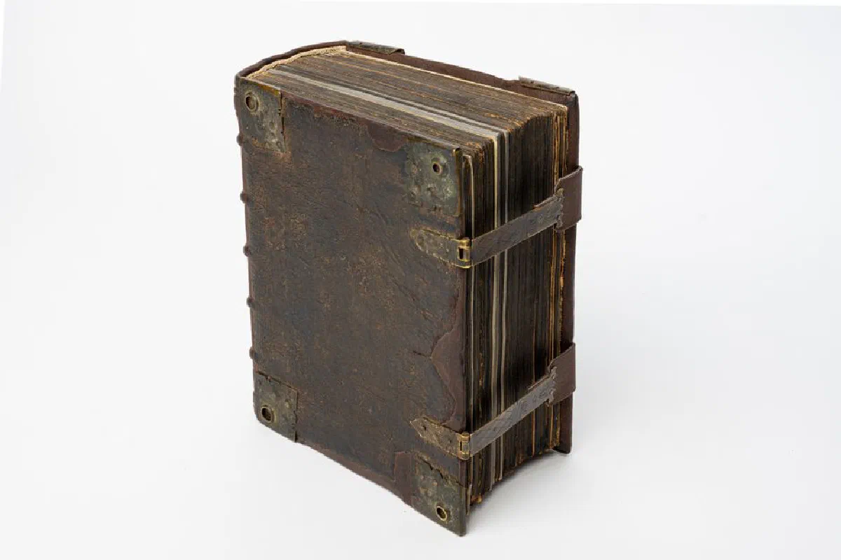 A detailed studio shot of an antique leather-bound manuscript, showcasing its aged and classic appearance.
