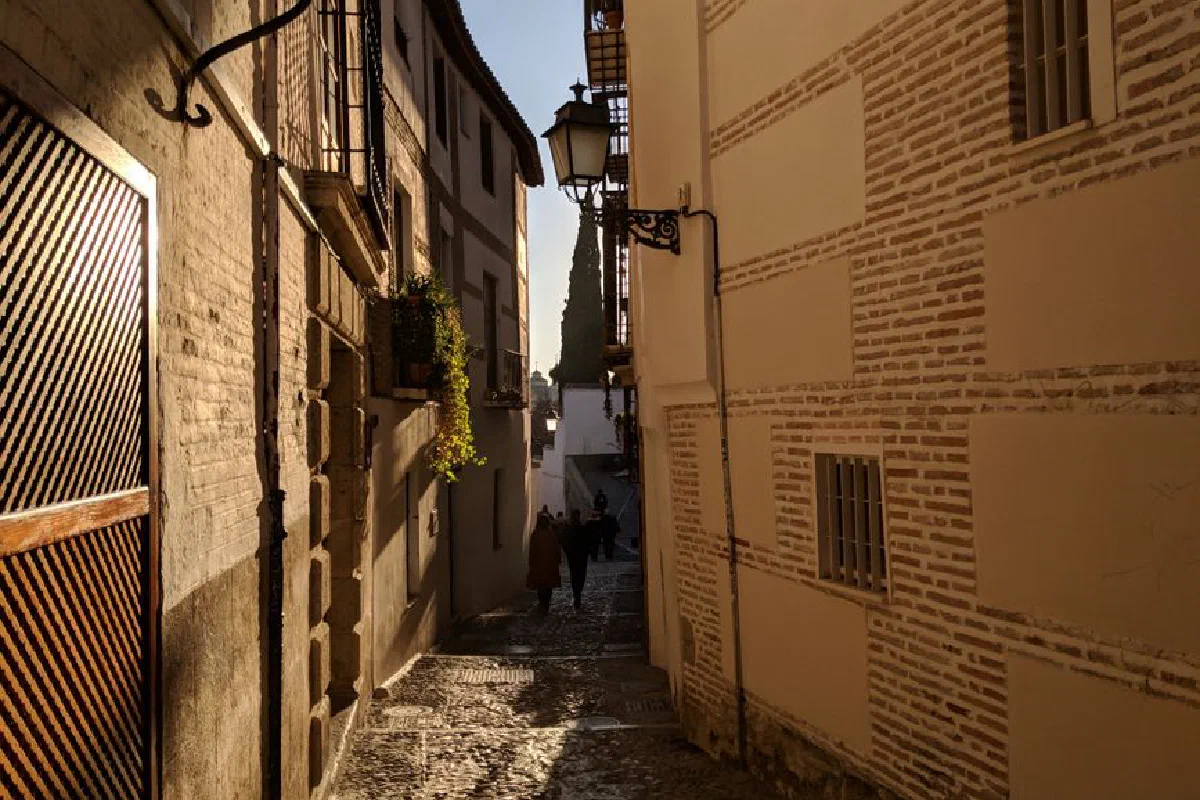 Explore the charming cobblestone streets of Granada, Spain at dusk, capturing timeless beauty.