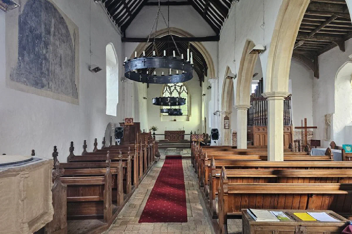 Beautiful church interior with wooden pews and chandeliers in Mutford, England. Serene and historic.