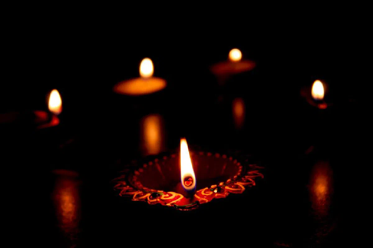 Diya candles illuminating the darkness in a symbolic festival of lights scene.
