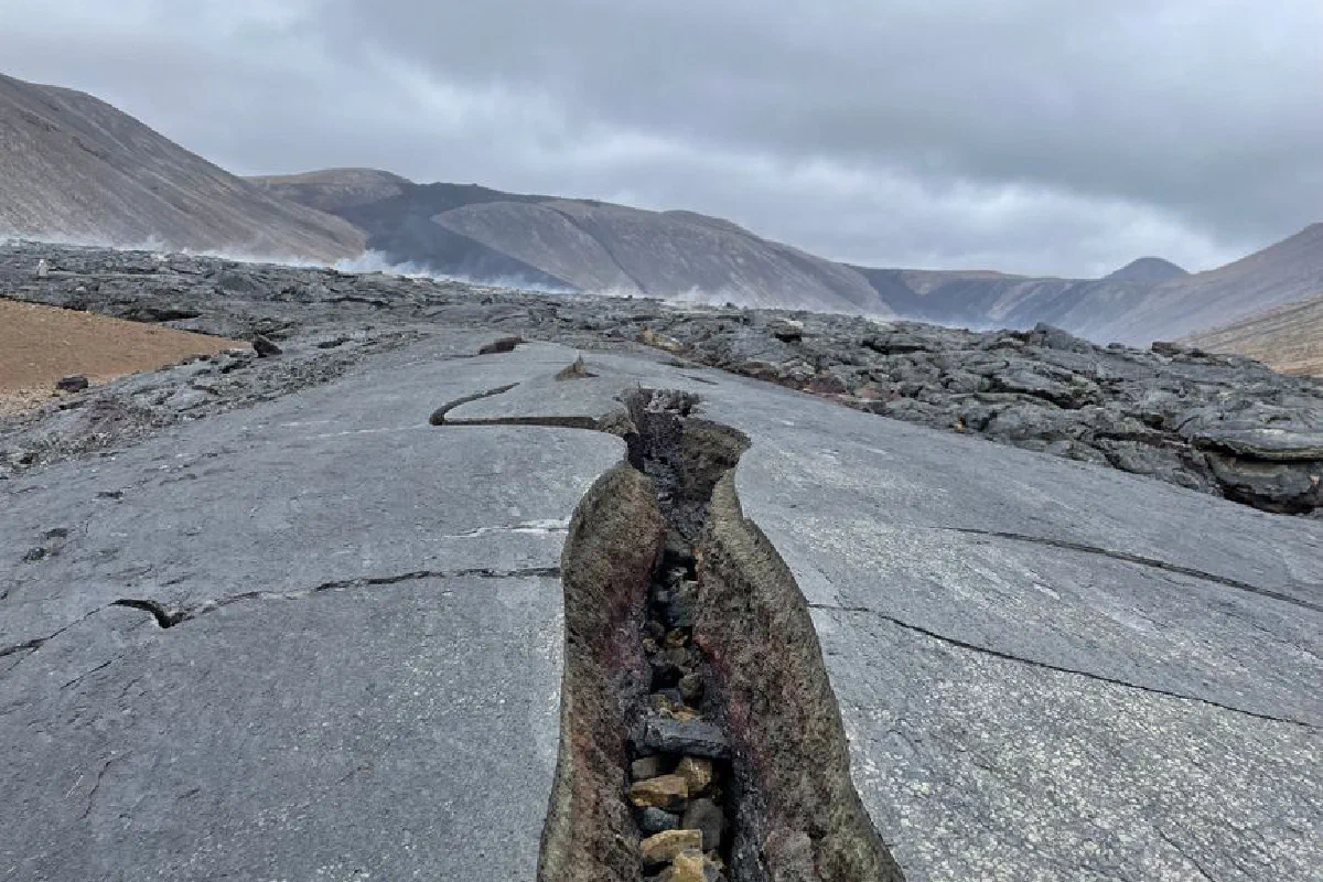 A cracked volcanic landscape near Reykjavík, Iceland showcasing rugged terrain and dramatic geology.